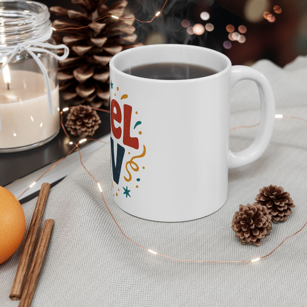 White mug with colorful text on a table with decorative items