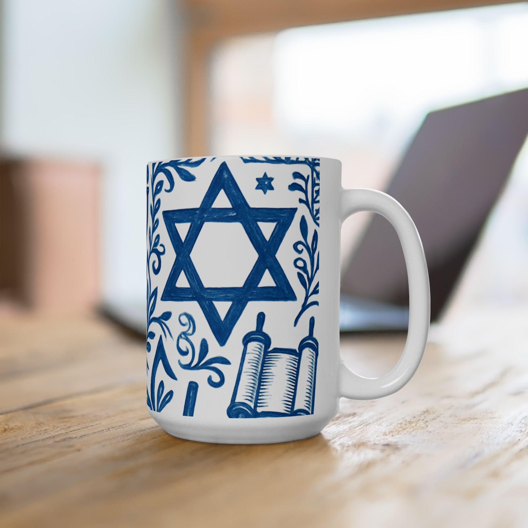 White mug with blue Star of David and book design on a wooden surface.