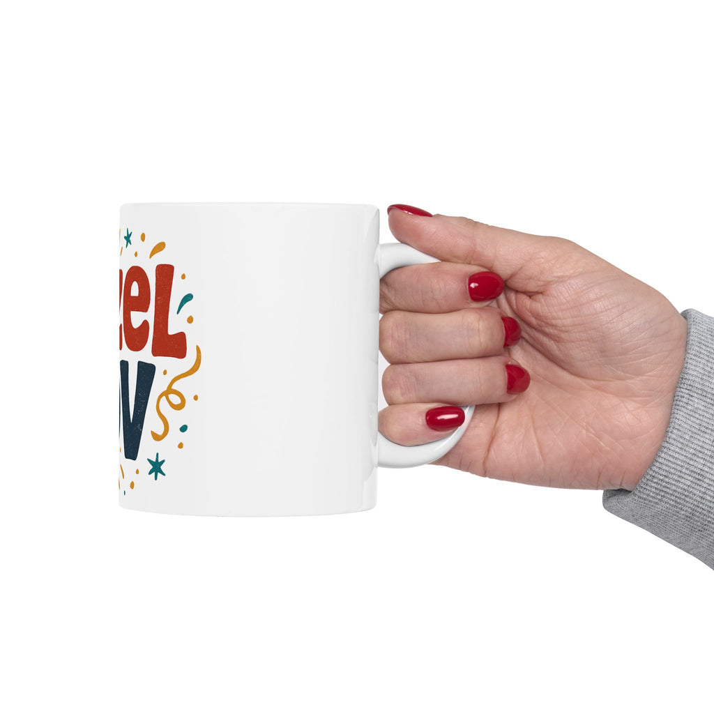 Hand holding a white mug with colorful text design on a white background