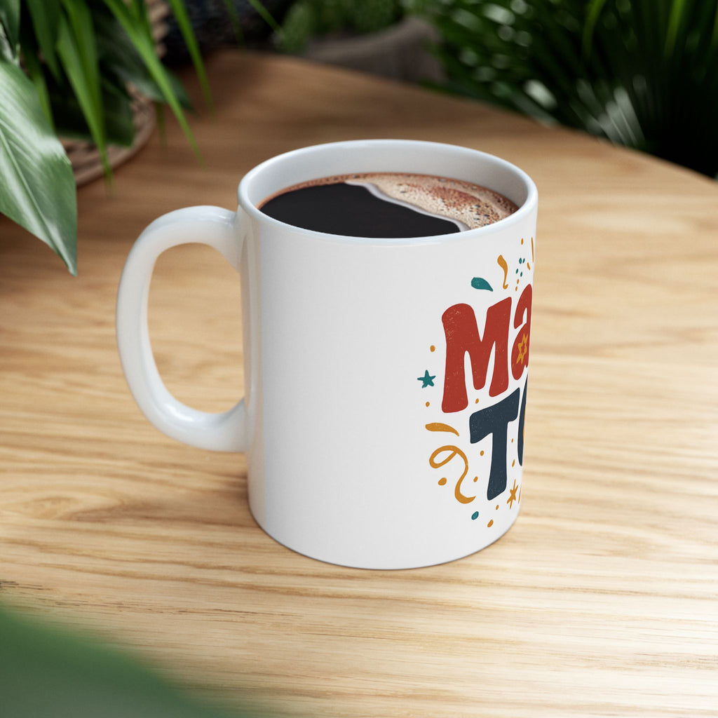 White mug with colorful text on a wooden table