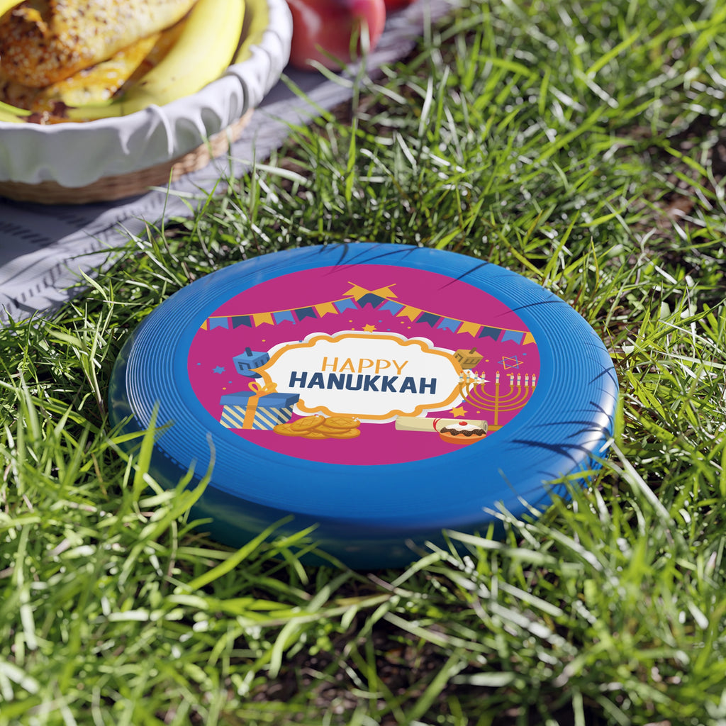 Blue frisbee with 'Happy Hanukkah' design on grass