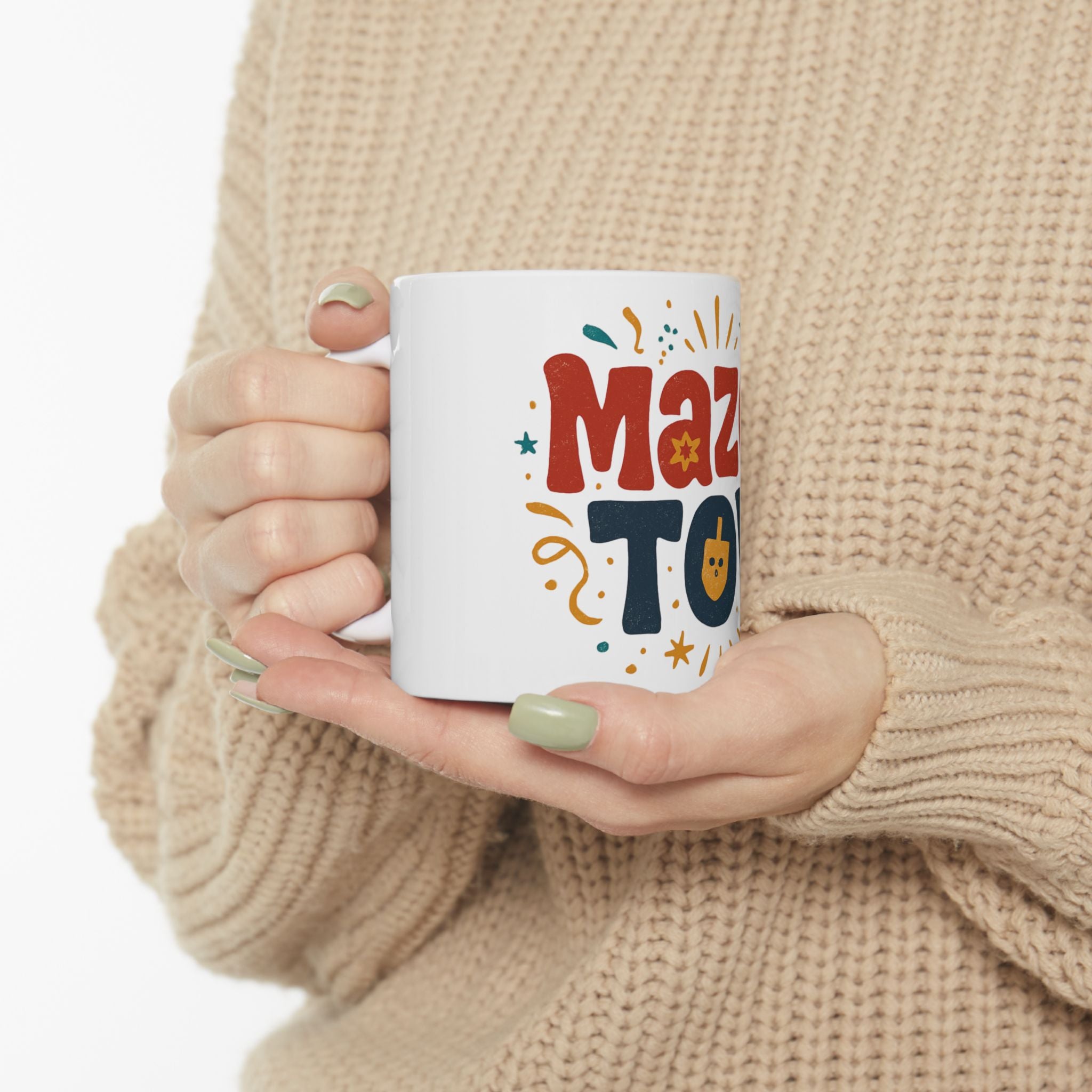 Person holding a mug with 'Maz To' text in a casual setting