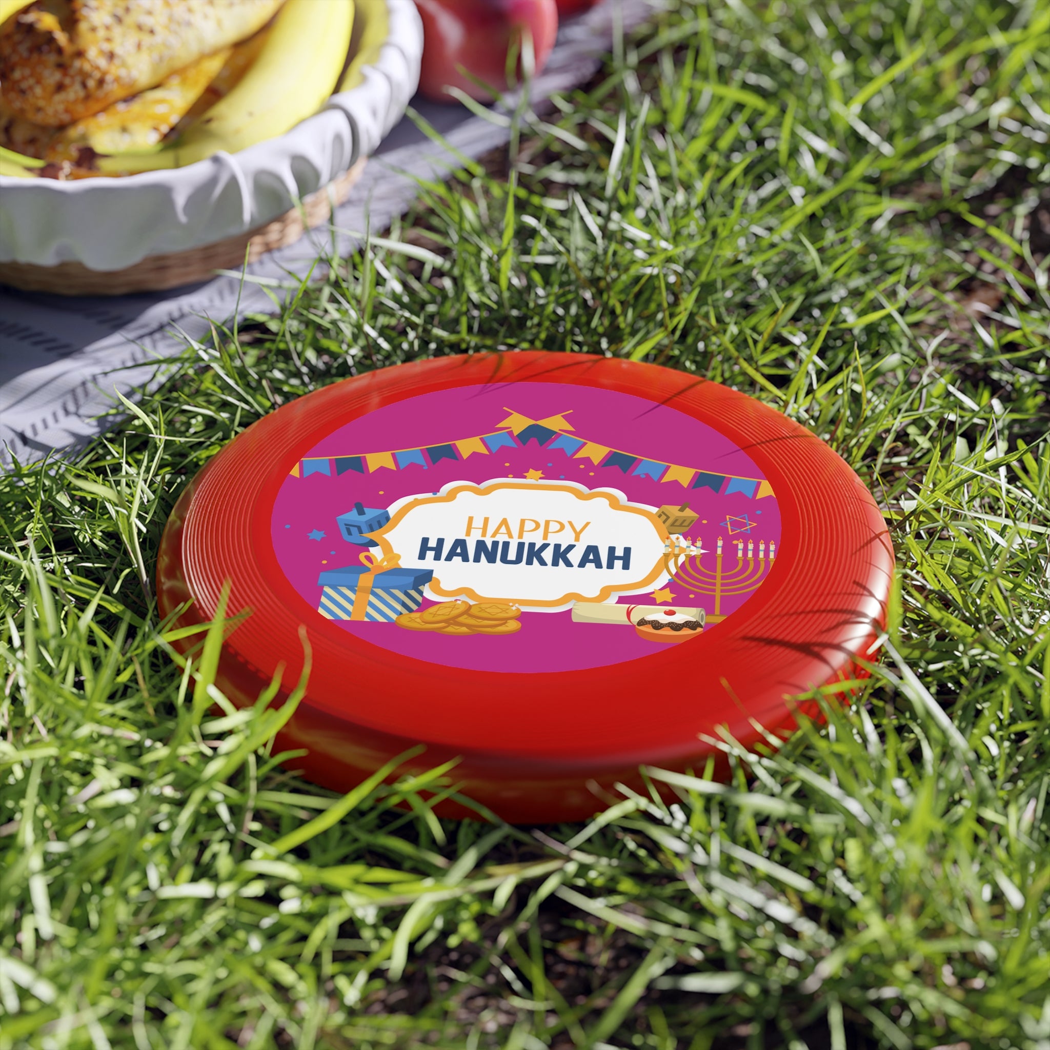 Red lid with 'Happy Hanukkah' text on grass