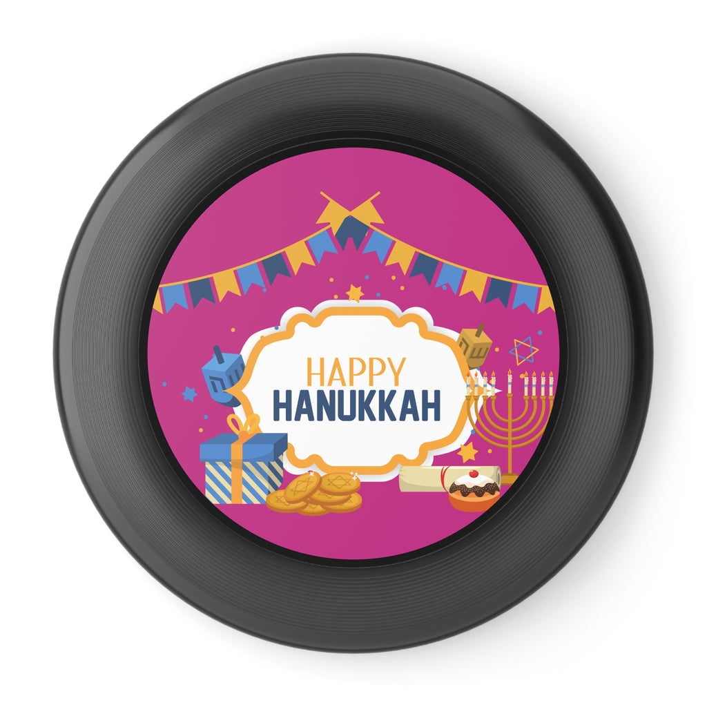 Black frisbee with 'Happy Hanukkah' design on a pink background